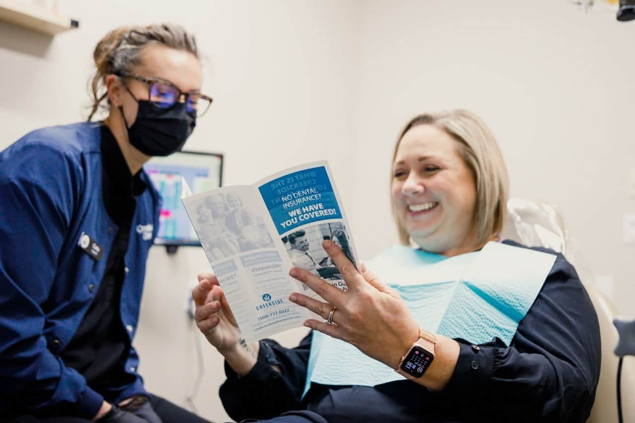 patient consult with her dentist about tooth fillings Creekside Dental