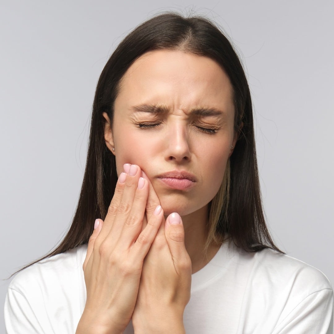 woman hurting from a dry socket after tooth extraction Creekside Dental