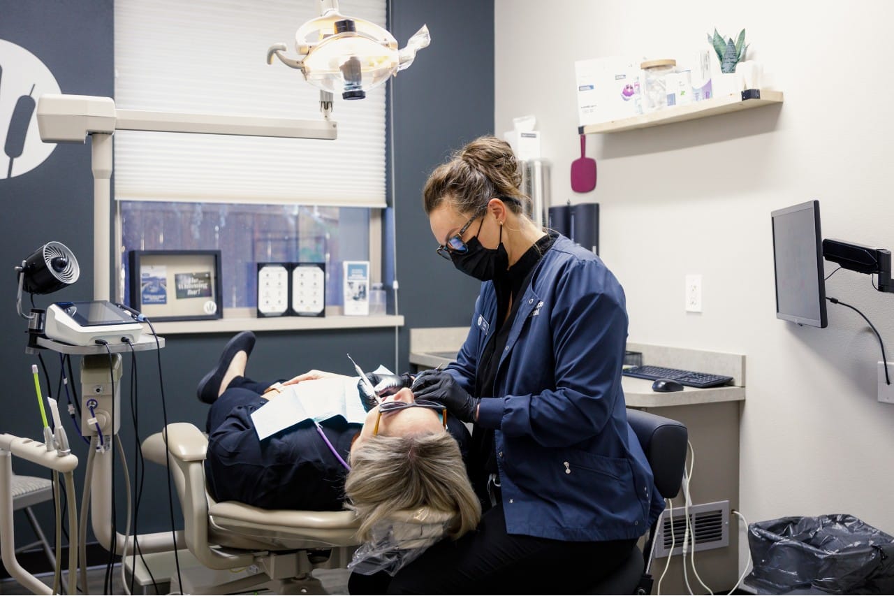 dentist providing dental care to patient Creekside Dental