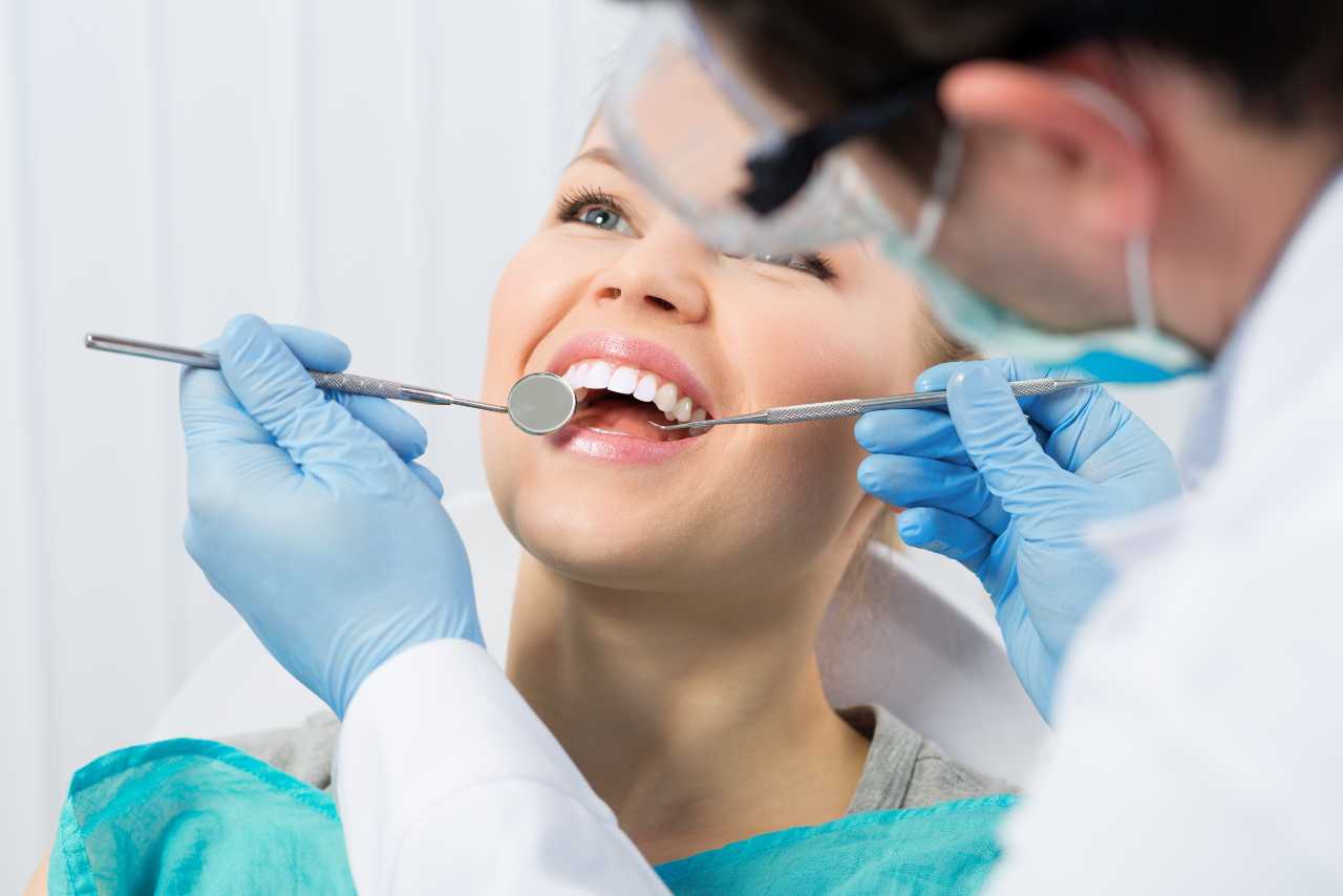woman visits her dentist for tooth repair Creekside Dental